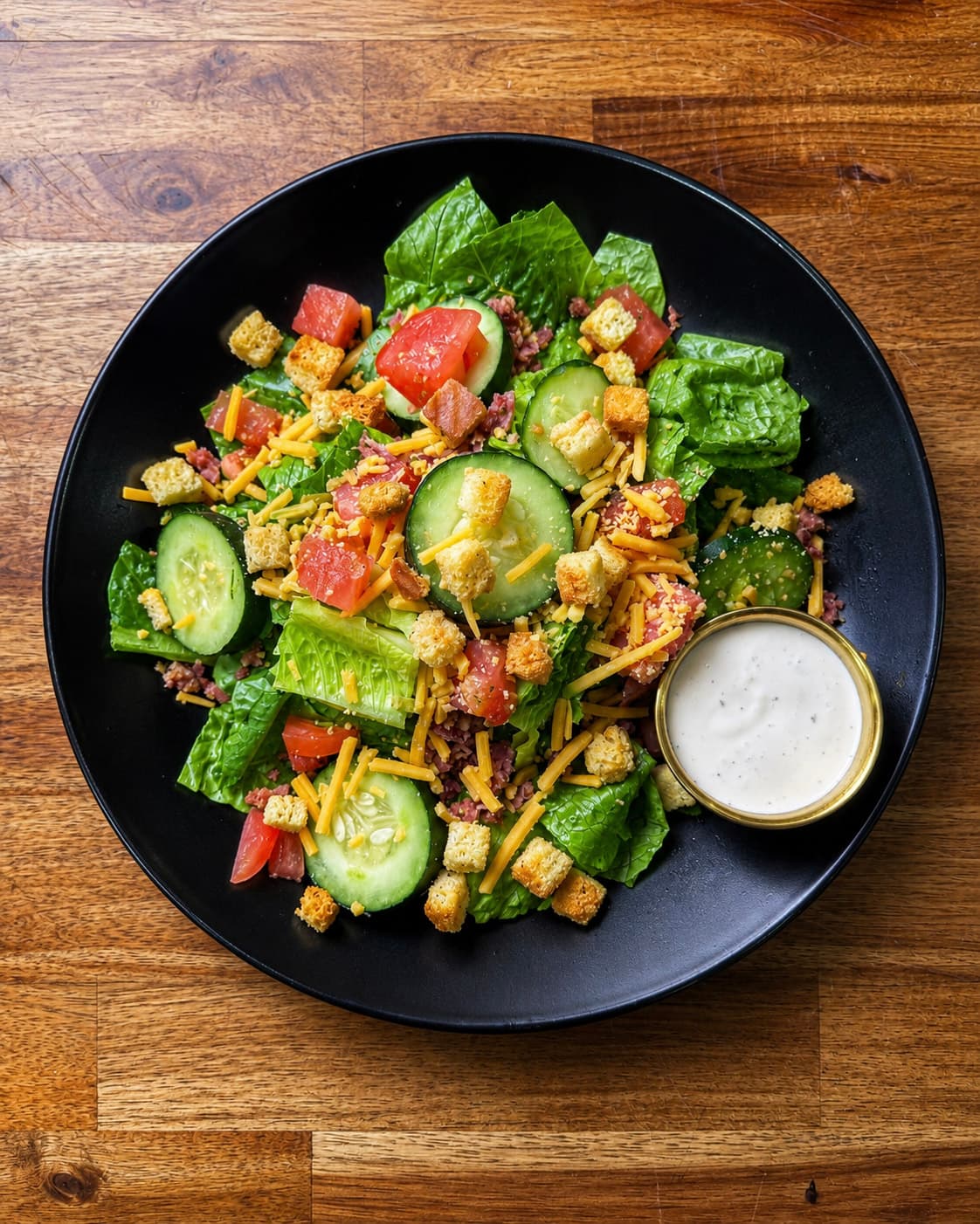 Chopped salad with bacon, cheddar, cucumber, tomato, and ranch