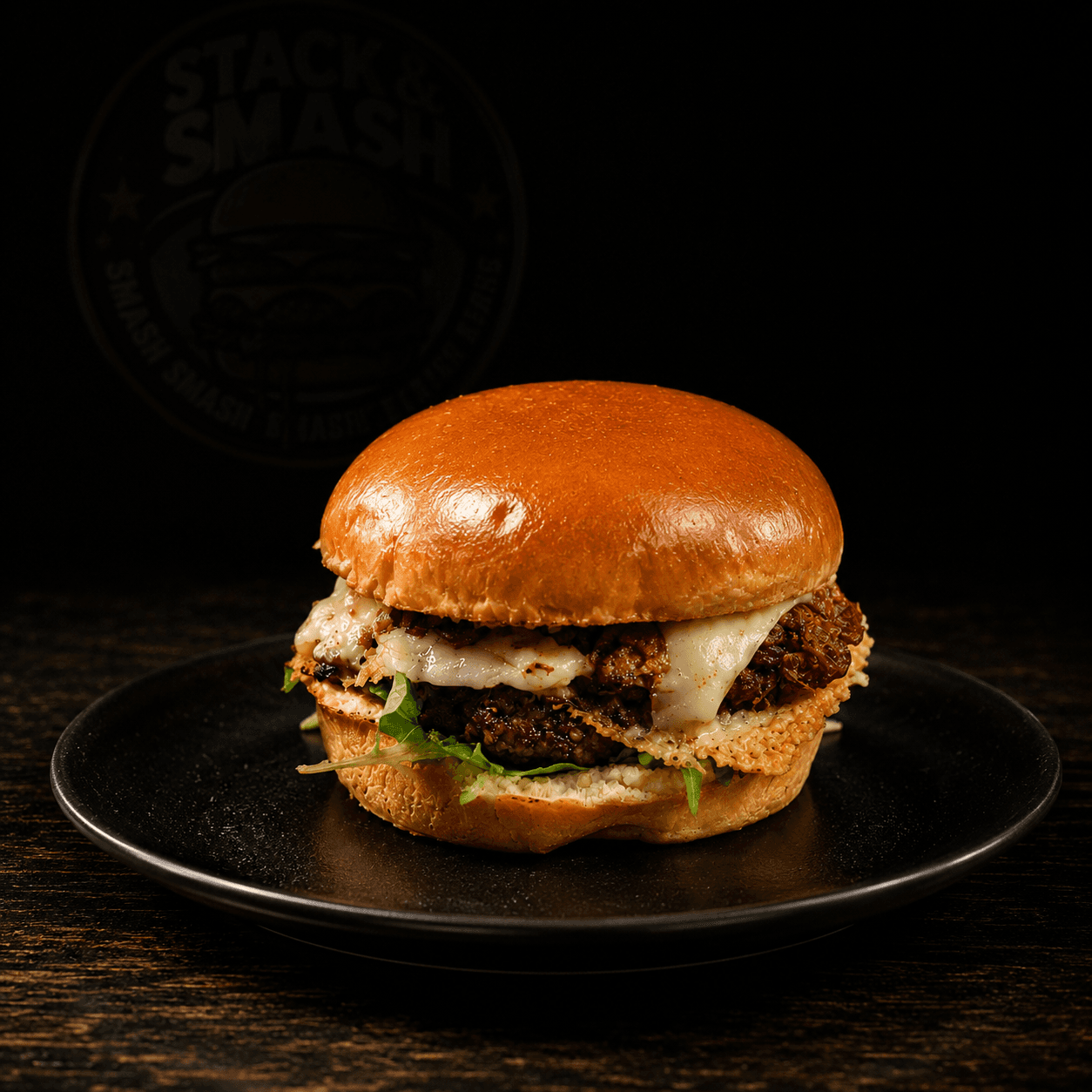 Rise and Smash burger with melted cheese, bacon jam, and arugula